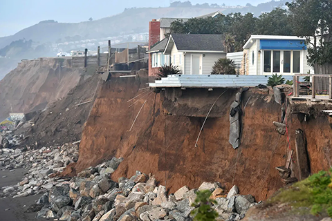 Sections of land are seen missing from coastal properties in Pacifica, Calif. on Jan. 26, 2016. Storms and powerful waves caused by El Nino worsened erosion along nearby coastal bluffs and beaches in the area.